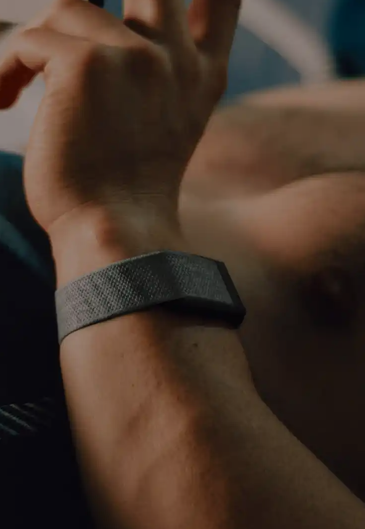 A smiling woman in fitness attire, with the Stella app interface displaying a '32 Skin Age' score. Below, three cards show 'Training Stress 87/100 (Good)', 'Sleep Score 56/100 (Average)', and 'Stress Score 75/100 (Moderate)', each with personalized advice. This image illustrates how Stella connects to wearables to show how sleep, stress, and daily habits affect skin, providing real signals from the body linked to clinical skincare advice.