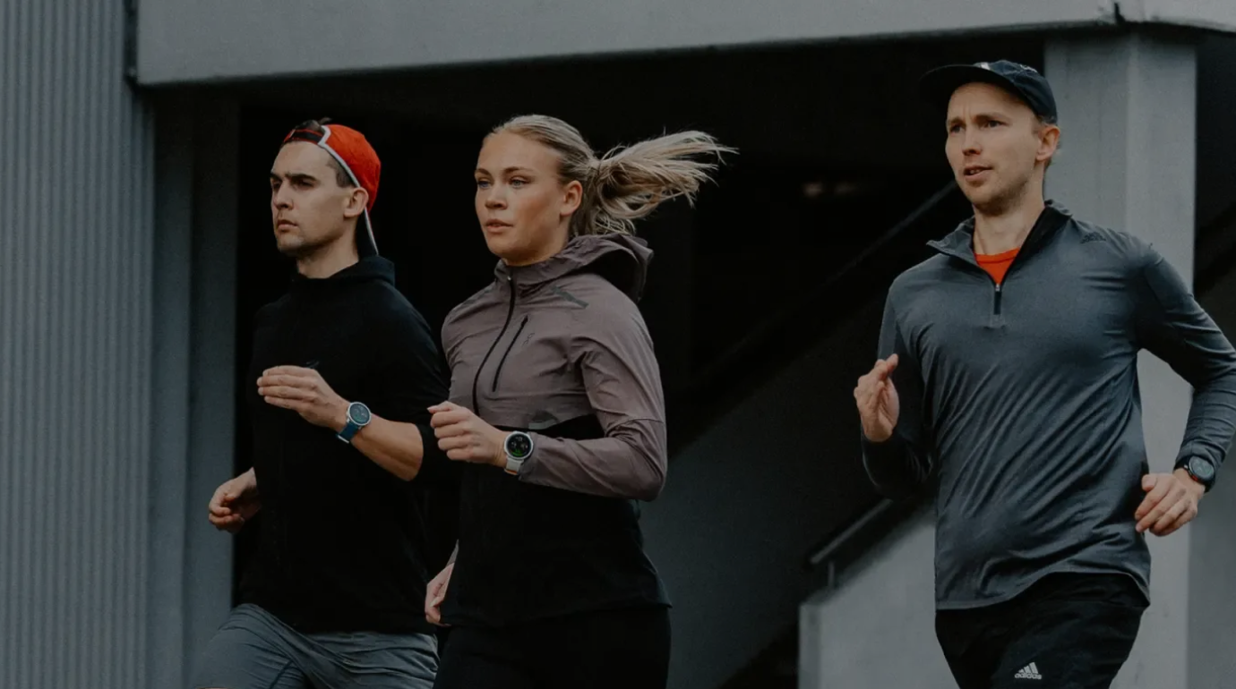 Three runners wearing Polar smartwatches jogging outdoors, representing endurance training data integration with Stella.