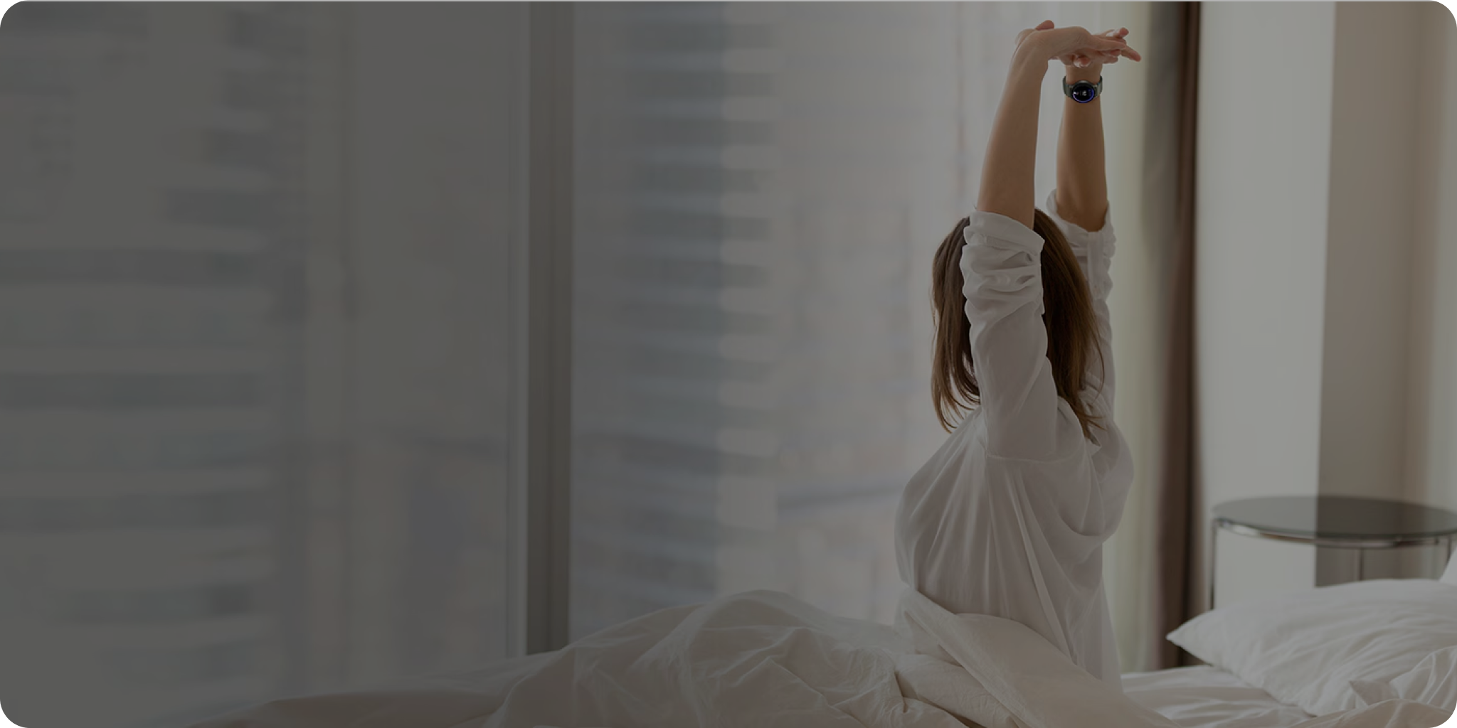 Woman stretching inside while wearing Samsung Galaxy Watch.