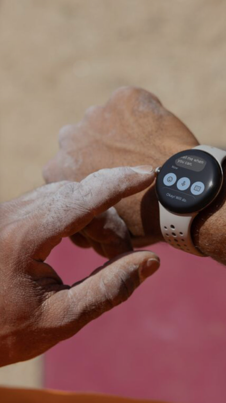 Woman wearing a Samsung Galaxy Watch smiling outdoors in a city